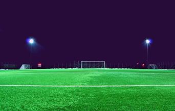 Empty football pitch at night with lights