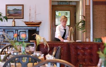 Inside view of waitress at 47 Mussel Row|Waitress working inside 47 Mussel Row restaurant