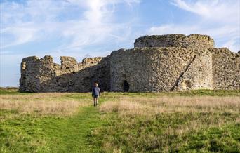 the front side of the ruins with a person walking towards them