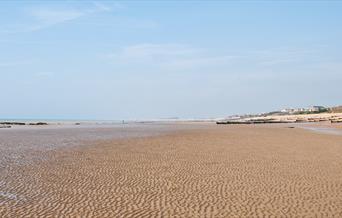 Cooden beach with blue skies and sand