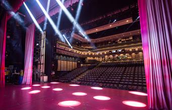 A view of the theatre from the stage showing the seat levels and galleries