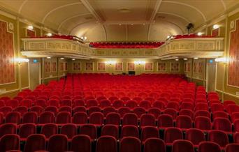 Empty red seats in a theatre
