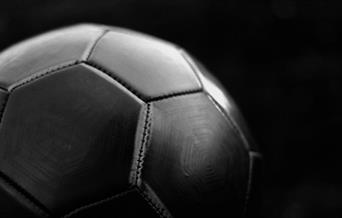 Black football on dark background