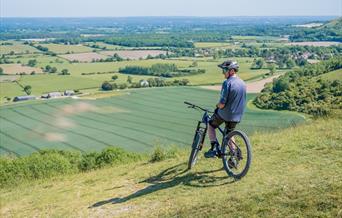 man on mountain bike over looking the downs
