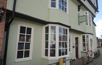 Front exterior of Horsham Museum. Historic building painted light green.