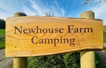 Newhouse Farm Camping wooden sign