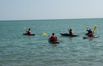 four people Kayaking on Brighton sea front