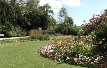 lawn and flower beds with trees