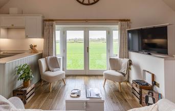 two chairs over looking field tv in room