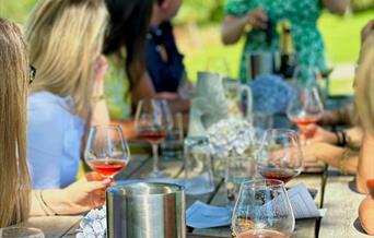 wine tasting in the sunshine at charles palmer vineyard