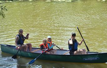 a family in a canoe on the river