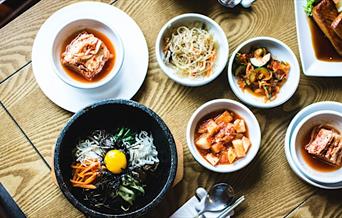 various plates of food arranged on a table