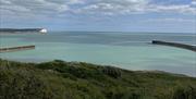 view out to sea with mouth of river Ouse and in the distance the seven sisters cliffs