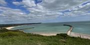 view out to sea with mouth of river Ouse and in the distance the seven sisters cliffs