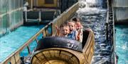 three children on a water chute ride with happy but screaming faces