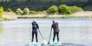 two people paddling on a river