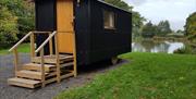 Sussex Shepherds Hut pictured in front of a lake
