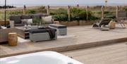 hot tub on decking by the sea