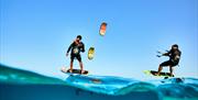 two foil kiters on the water