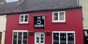 the red building with the sign The PulBrew