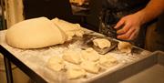 Dough being cut on a board
