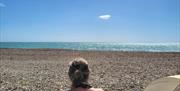 Woman in deck chair looking out to sea at Widewater sauna