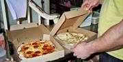 Pizzas in takeaway boxes