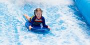 child playing on the surf machine
