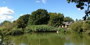 Tack Barn holiday cottage viewed over the pond