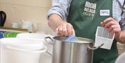 Demonstration of sampling during the cheese making process