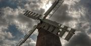 an external view of the mill under a few clouds