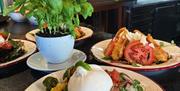A fresh and vibrant selection of handcrafted salads, bursting with colourful Mediterranean ingredients and beautifully presented in a rustic Italian s