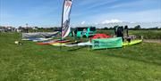 paddleboards laid out on the grass at Ferring ready for hire
