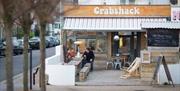 Diners enjoying outside seating area at Crabshack