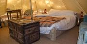 A bed inside of a yurt