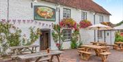Exterior of Tiger Inn with benches outside