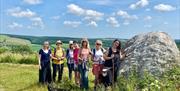 group of walkers beside chalk stone