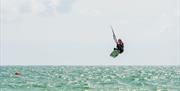 A kiter in the air on a windy day