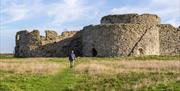 the front side of the ruins with a person walking towards them