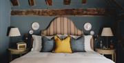 Bed in a wooden beamed room at The Swan