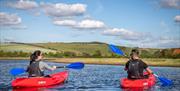 a couple kayaking on cuckmere meanders