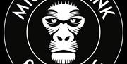 Missing link logo - black and white circle with Missing Link Brewing around the edge and a styliseed white monkey face at the centre