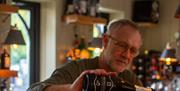 Jasper pouring the drinks at The Boathouse, Amberley