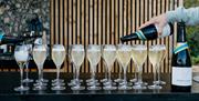 glasses of sparkling wine being poured