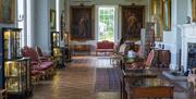 The Long Gallery at Firle Place in Sussex, with artwork and antique furniture on display