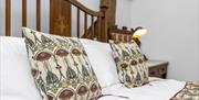 a bed with two cushions on the pillows