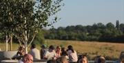 People drinking outside at Gun Brewery & Taproom