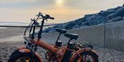 An ebike parked on the beach