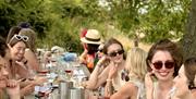 group of friends drinking wine outside on a Sussex vineyard