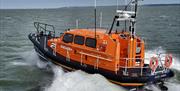 Selsey Shannon class all weather lifeboat afloat in choppy sea